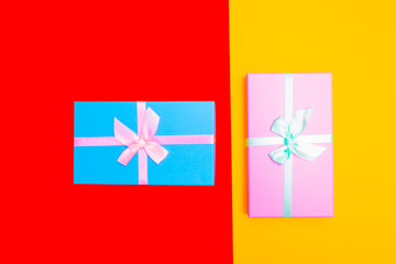 Poster - colored boxes with ribbons on a colorful background. view from above.