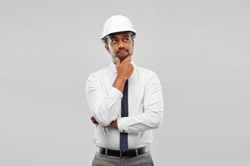 Poster - architecture, construction business and people concept - thinking indian male architect in helmet over grey background