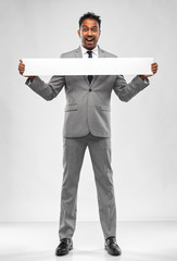 Sticker - business, people and corporate concept - happy indian businessman with white banner over grey background