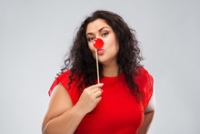 Red Nose Day, Party Props And Photo Booth Concept - Happy Woman With Clown Nose Posing Over Grey Background