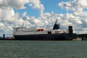 Big freighter or cruise ship loading at the harbor. Industrial container ship at terminal. Exporting products on a global scale