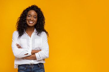 Confident smiling african american girl with crossed hands on chest