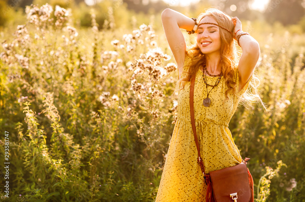 Obraz na płótnie Smiling bohemian girl in yellow dress with guitar on the field at sunset warm light w salonie