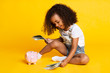 © Prostock-studio - Little afro girl playing with money banknotes