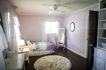 Young girl's light purple lavendar lilac bedroom with hardwood floors and windows