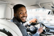 © Prostock-studio - Young afro businessman at driver's seat smiling to camera
