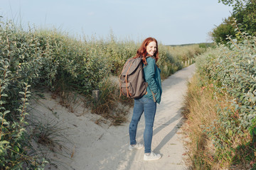 Happy friendly young woman backpacker