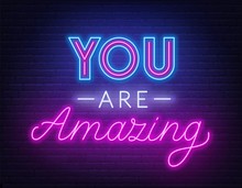 You Are Amazing Neon Lettering. Neon Sign On Brick Wall Background.