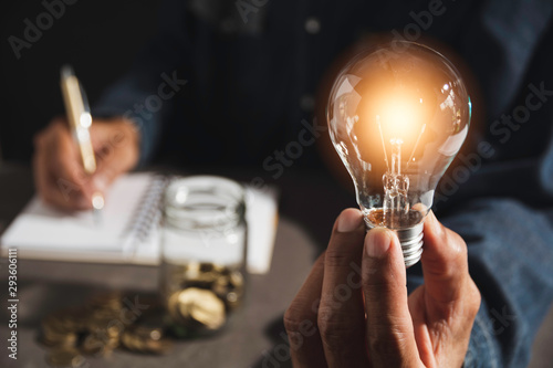 Fotomural Hand of male holding a light bulb and copy space for accounting, ideas and creative concept