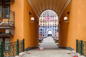 Wall Mural - building exterior authentic home with orange archway and children's toy in residential area community mixed-use urban multi-family residential district area development.