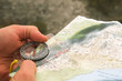 Explorer using a compass and topographic map