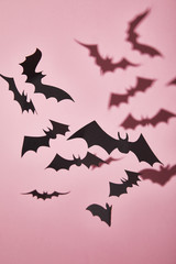 Wall Mural - black paper bats with shadow on pink background, Halloween decoration