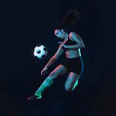 Wall Mural - Fit young girl kicking soccer ball