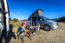 Motorhome RV Or Campervan Is Parked On A Beach.