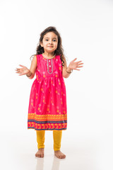 portrait of cute little indian girl model, standing isolated over white background