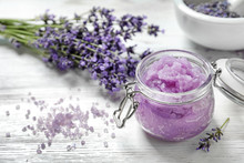 Natural Sugar Scrub And Lavender Flowers On White Wooden Table, Space For Text. Cosmetic Product