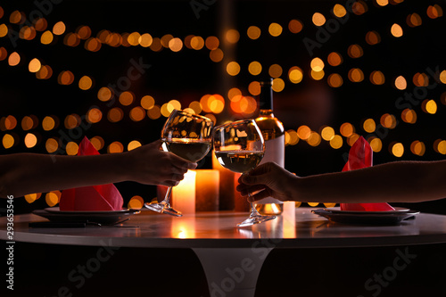 Cuadros en Lienzo Young couple with glasses of wine having romantic candlelight dinner at table, c