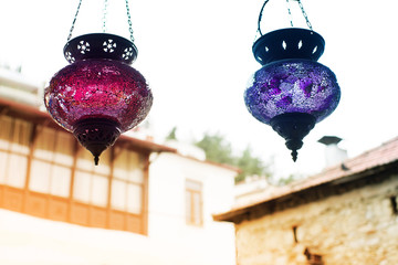 Two glass Turkish red and blue decorative lanterns in the city