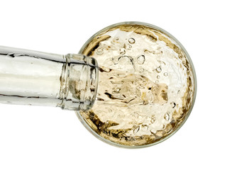 White wine pouring in a glass, top view