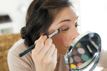 portrait of woman doing her make-up