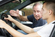 driving instructor gesturing to young learner driver