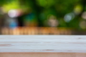 Wall Mural - Empty wooden table texture, Green garden bokeh blurred background, Selective focus