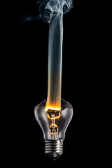 broken light bulb and smoke from a burning spiral on a black background