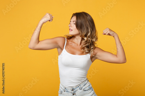 Fotomural Strong young woman girl in light casual clothes posing isolated on yellow orange wall background studio portrait