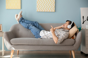 Canvas Print - Handsome man listening to music at home