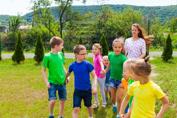 Wall Mural - Kids with tutor go to the playground in the summer camp