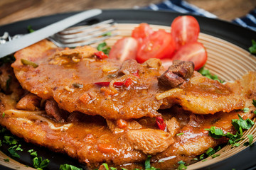 Wall Mural - Potato pancakes with meat, vegetable, tomato and parsley.