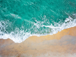 Top view of green turquoise sea water. Capture sea wave and beach in summer.