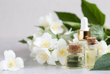 Essential Jasmine Oil. Massage Oil With Jasmine Flowers On A Wooden Background