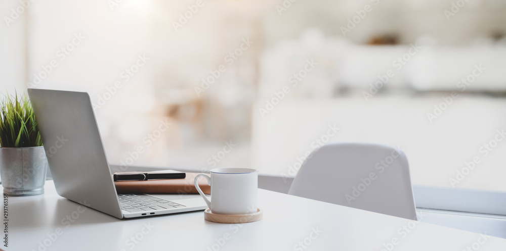 Modern workplace with laptop computer, coffee cup and office supplies - obrazy, fototapety, plakaty 
