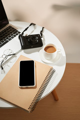 Wall Mural - Office desk with mobile phone, coffee cup, laptop, camera and glasses