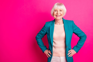 Wall Mural - Portrait of her she nice-looking attractive lovely cheerful cheery content gray-haired lady wearing blue green jacket posing isolated over bright vivid shine vibrant pink fuchsia color background