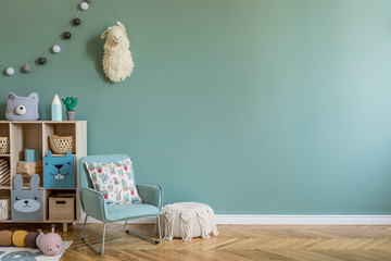 Wall Mural - Stylish scandinavian newborn baby room with wooden cabinet, toys, children's mint chair, natural basket Modern interior with eucalyptus background walls, wooden parquet and cottona balls. Home decor.