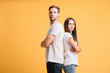 © LIGHTFIELD STUDIOS - offended couple standing with crossed arms, isolated on yellow