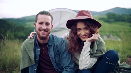 Wall Mural - young tourist couple travellers with tent shelter sitting in nature, resting.