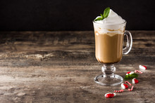 Peppermint Coffee Mocha For Christmas On Wooden Table And Black Background.  Copy Space