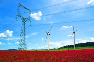 Wall Mural - high voltage power lines with wind turbines in crimson clovers field. renewable electric energy prod