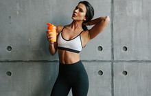 Young Brunette Fitness Woman With Sportive Nutrition Shaker In Brutal Concrete Gym