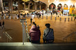 Two boys seats on the floow of stratford station of London Uk, and looking towards the stratfor shopping center