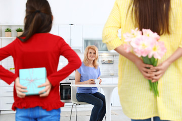 Sticker - Woman and her daughter congratulating granny in kitchen. Happy Mother's Day