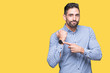 © Krakenimages.com - Young handsome man over isolated background In hurry pointing to watch time, impatience, upset and angry for deadline delay