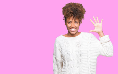 Beautiful young african american woman wearing winter sweater over isolated background showing and pointing up with fingers number five while smiling confident and happy.