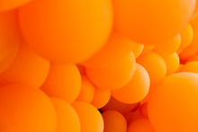Festive Composition With Bunch Of Matte Orange Balloons. Macro Shot, Close Up, Background With A Lot Of Copy Space For Text.