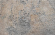 Texture of the stone sandy-grey with cracks, stains.