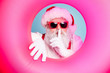 Close-up portrait of his he nice attractive mysterious bearded Santa in inflatable circle showing shh symbol sale discount isolated over bright vivid shine vibrant blue turquoise color background