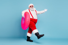 Full Length Body Size View Of His He Nice Cool Stylish Cheerful Fat Santa Walking Carrying Pink Inflatable Circle Isolated On Bright Vivid Shine Vibrant Blue Turquoise Color Background